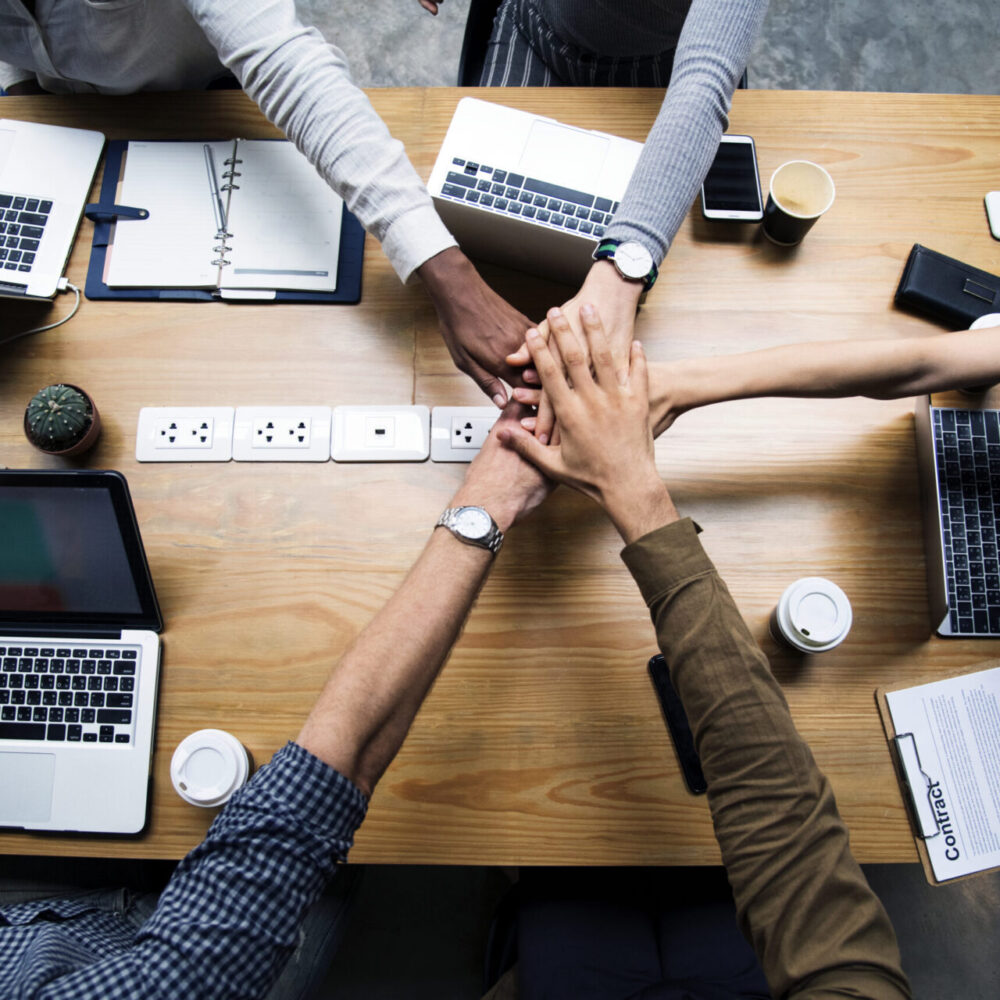 Team of business people stacking hands